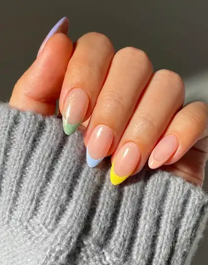 Pastel Skittle French Tips on Glitter Base design on short oval nails