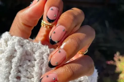 black french tip design with simple silver dots art on short oval nails