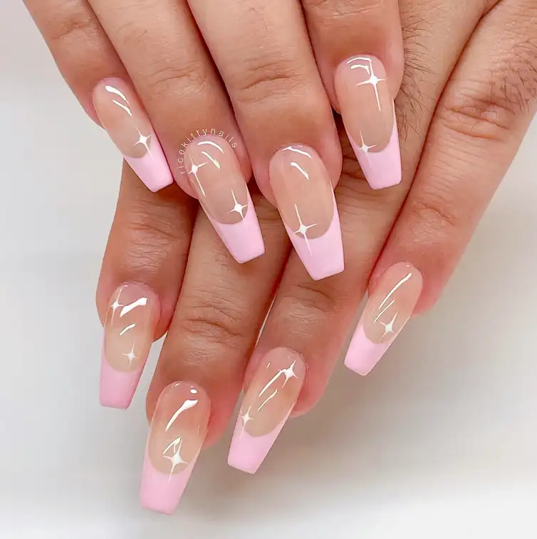 light pink french tips with white star art on long coffin nails