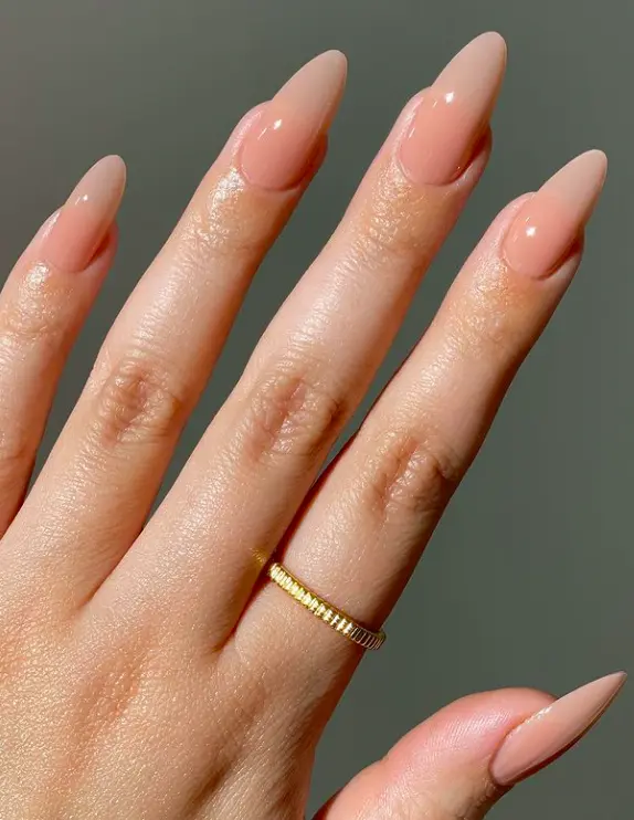 light nude polish on long oval nails