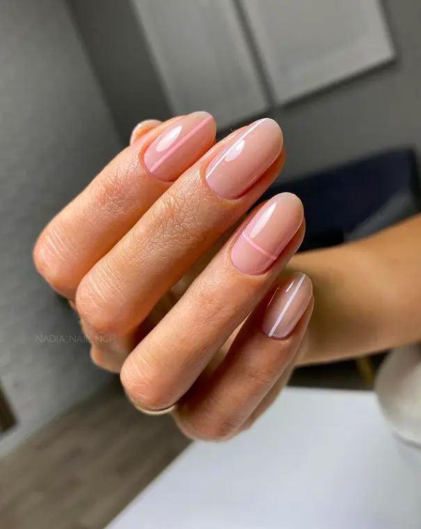 short oval nails with nude base light pink and white single thin lines